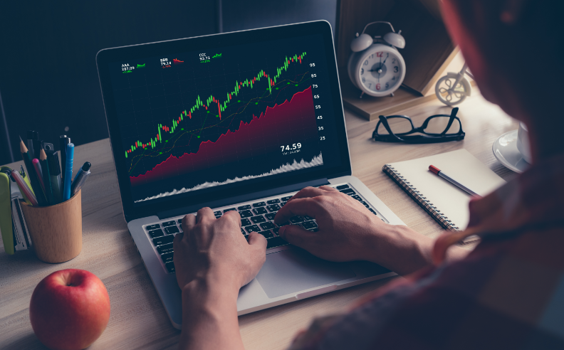 a man shows stocks graphs on the notebook
